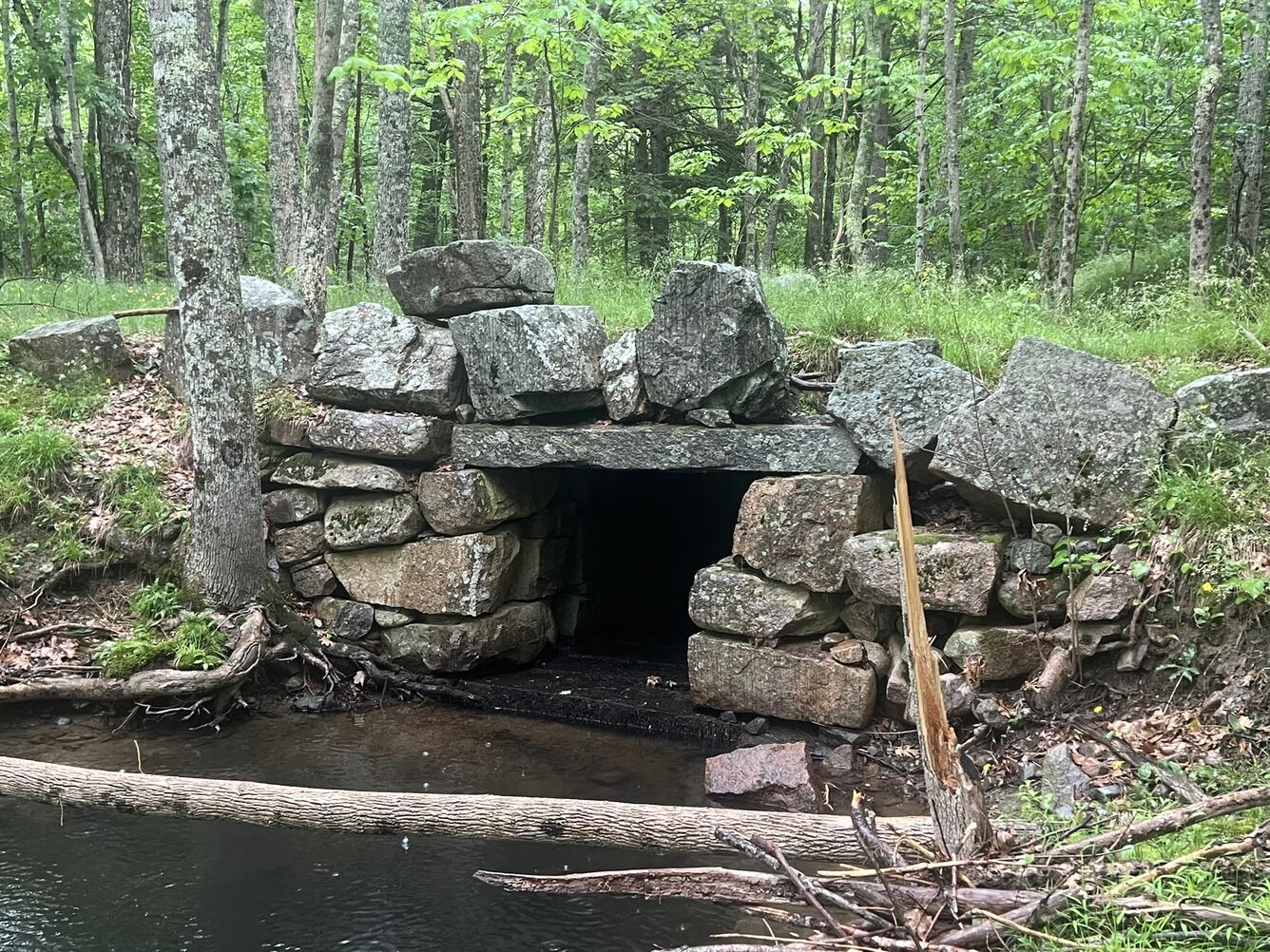 A culvert made with large boulders in a small stream.