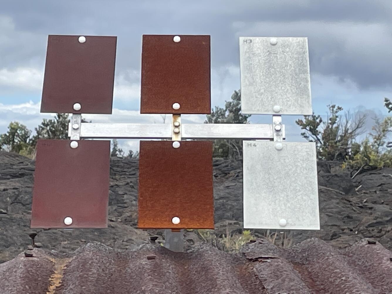 Color photograph of metal rectangles with varying amounts of corrosion