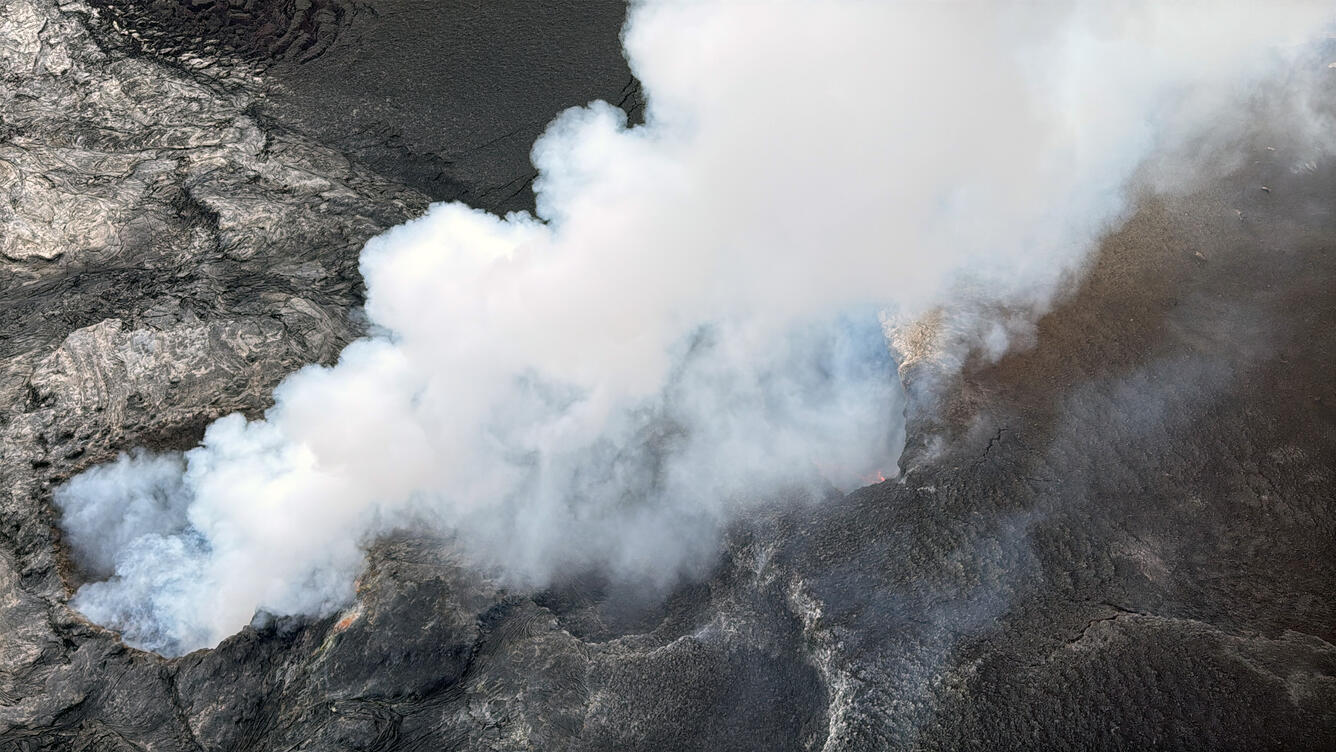 White volcanic gas plume being emitted from vents