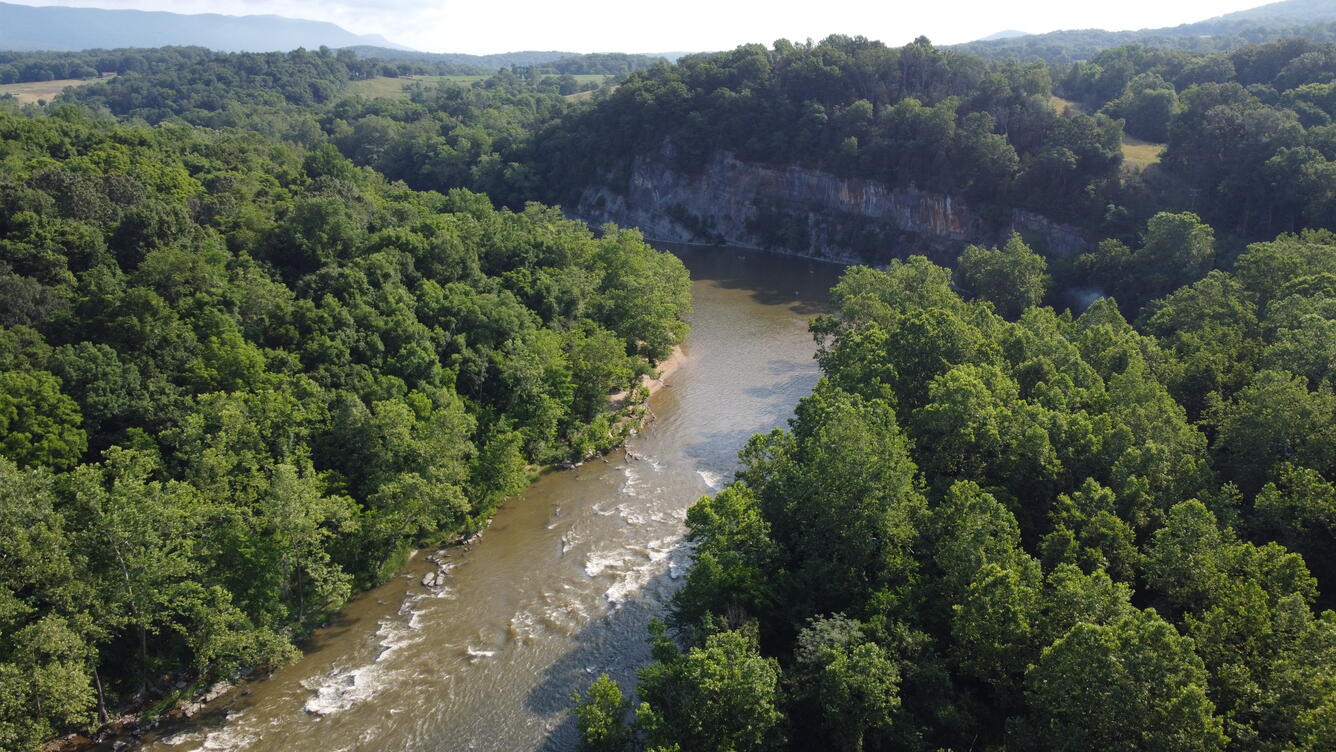 Aerial photo of the south fork of the Shenandoah River after a storm. The water flows fast and is very turbid.