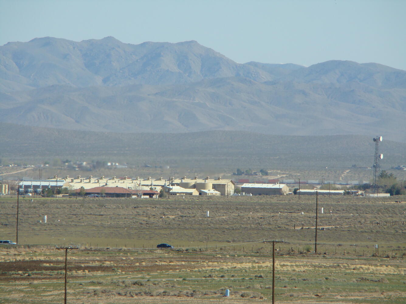 industrial buildings and machinery with mountains in back