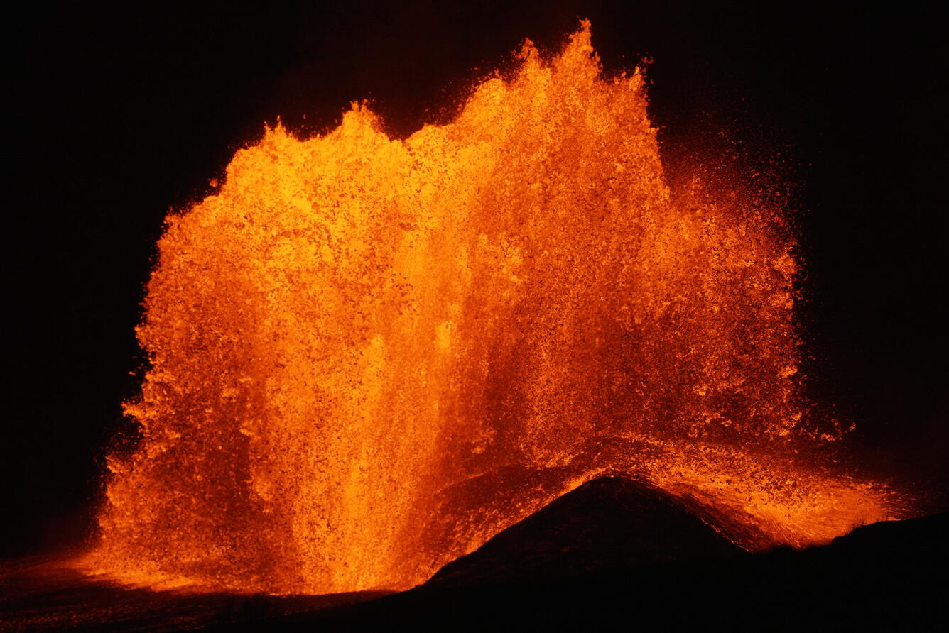Color photograph of lava fountain at night