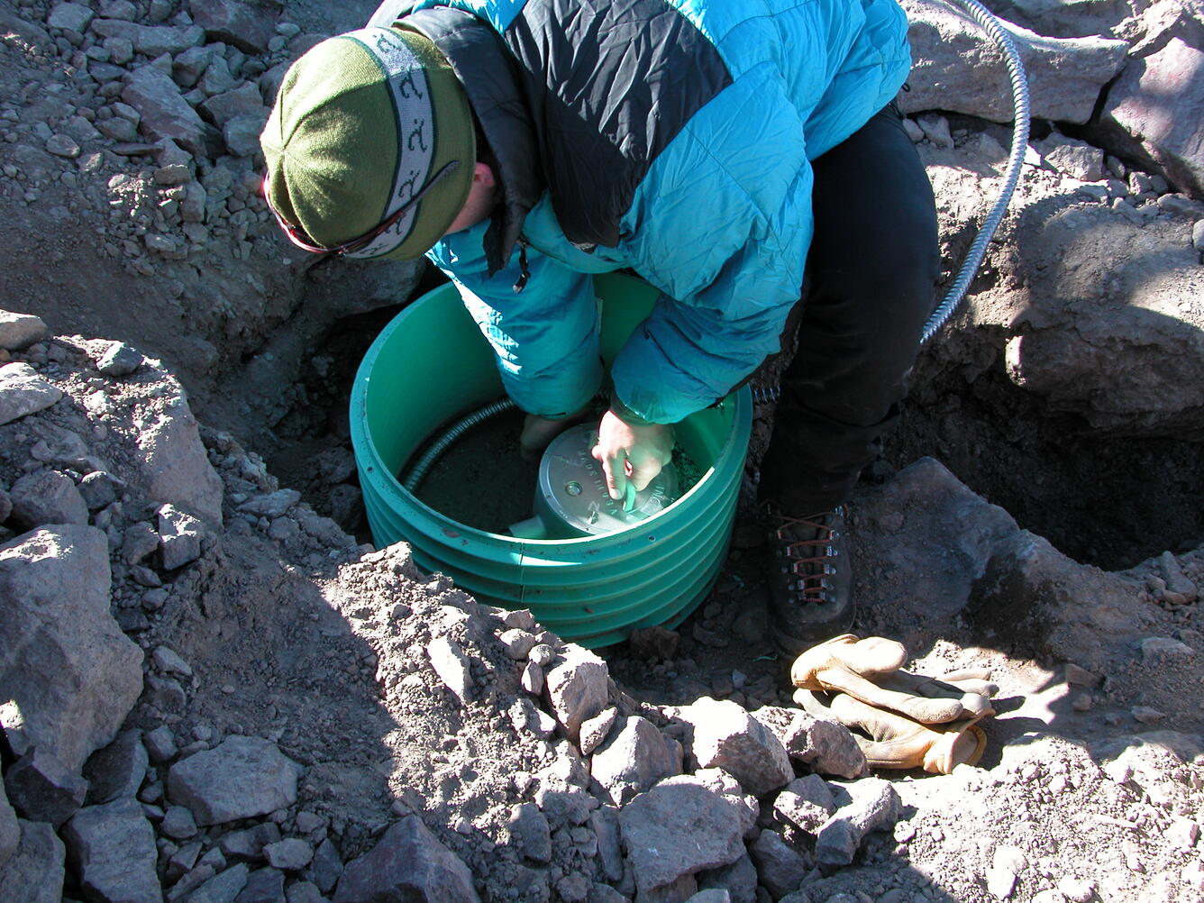 USGS seismologist installs a seismometer as part of a volcano monitoring network. 
