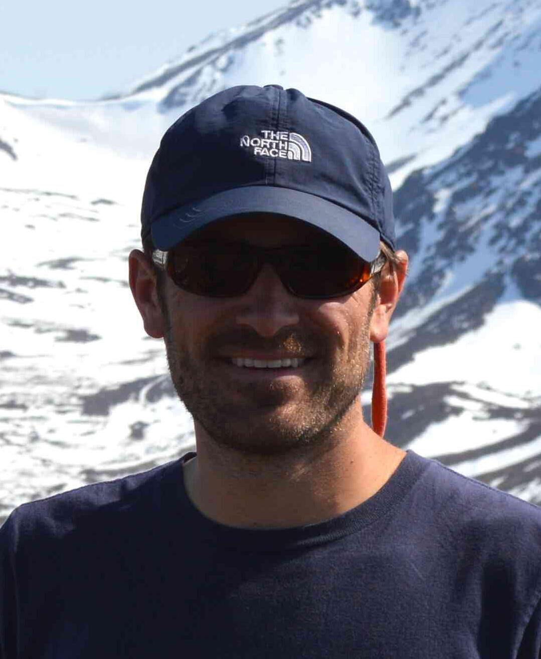 photo of Stephen J. Angster with snowy mountains in the background