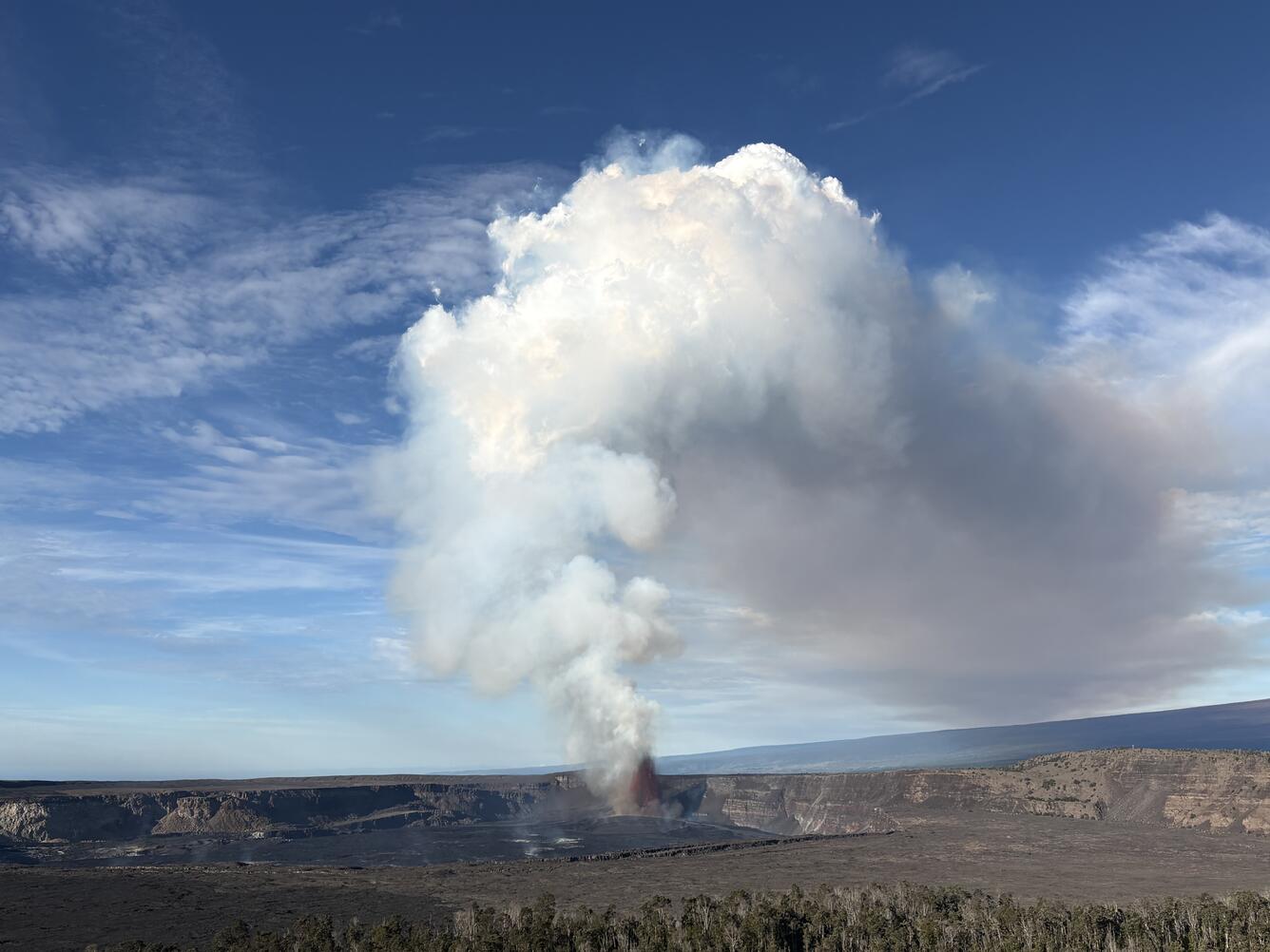 color photo looking towards the lava fountain producing a large stream cloud
