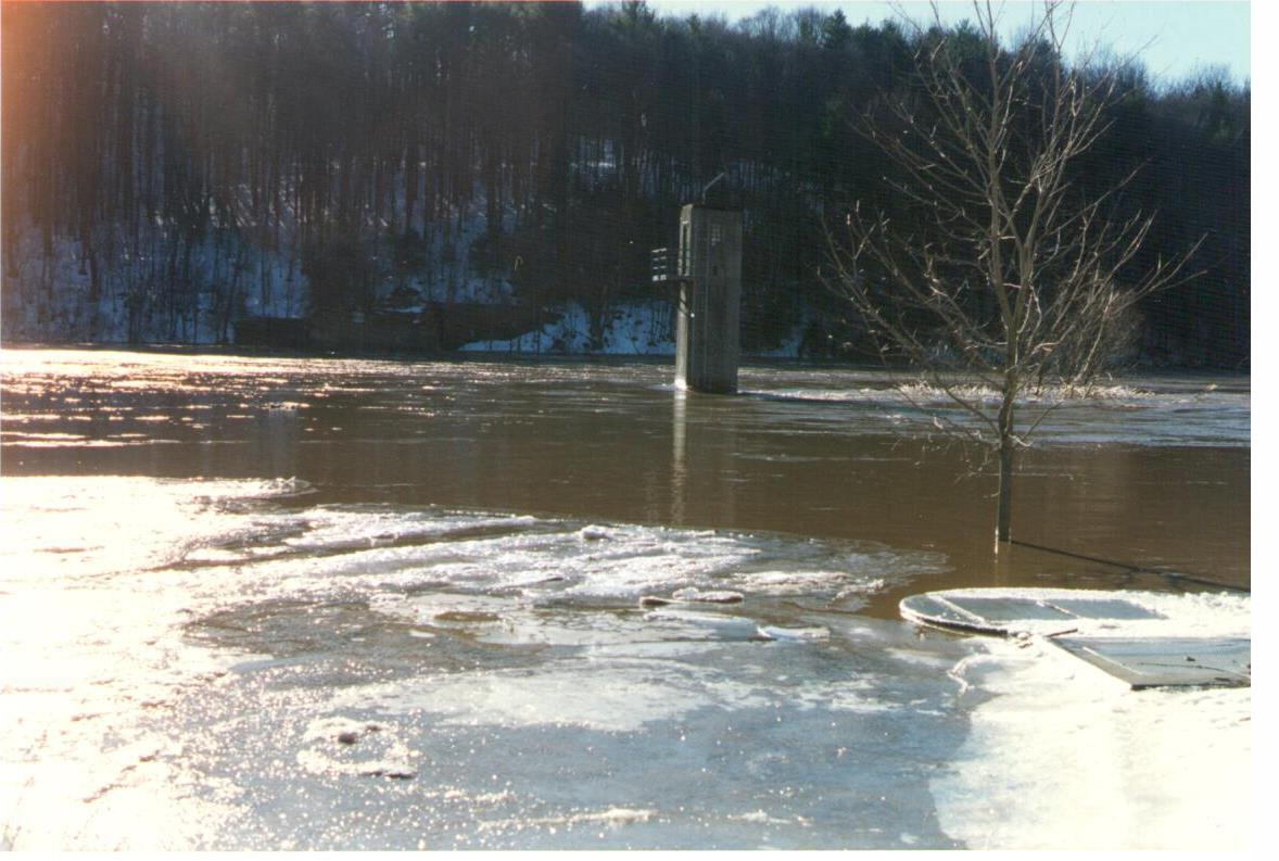 Looking out over the flooded Delaware river at the gage house standing alone in the waters