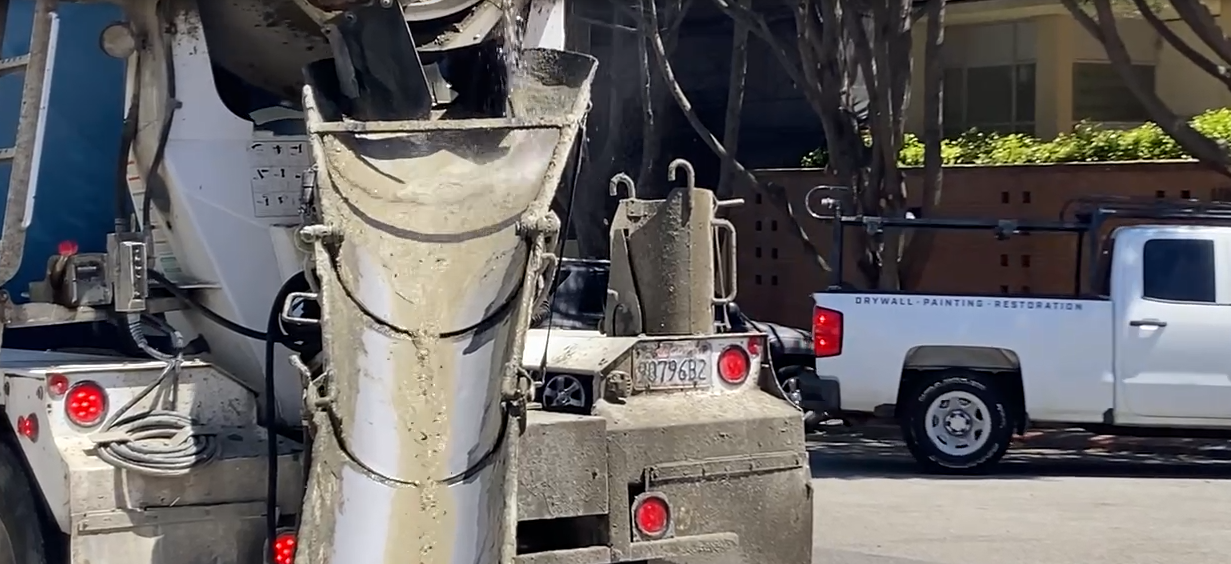 water and cement coming down a slide out of truck
