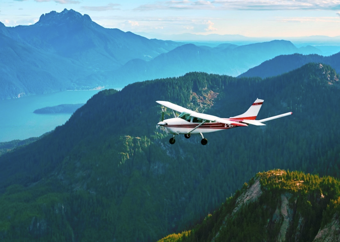 Airplane in flight over mountains