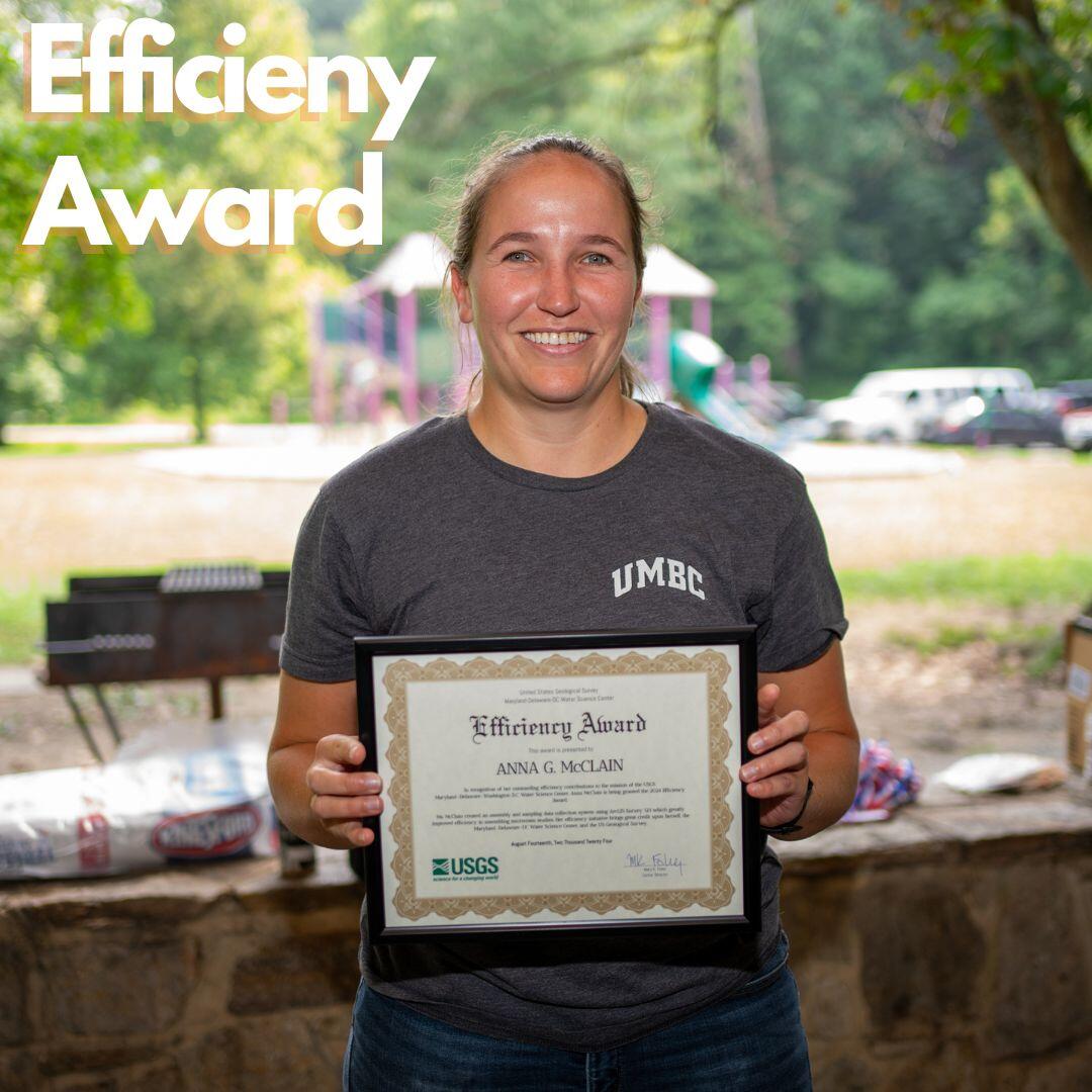 Anna McClain poses for a photo with an award plaque.