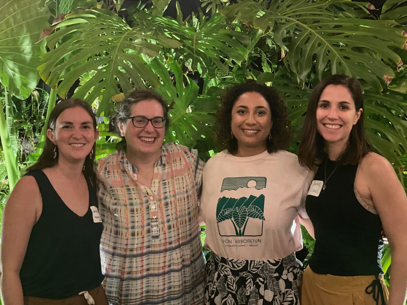 Four women smile into the camera.