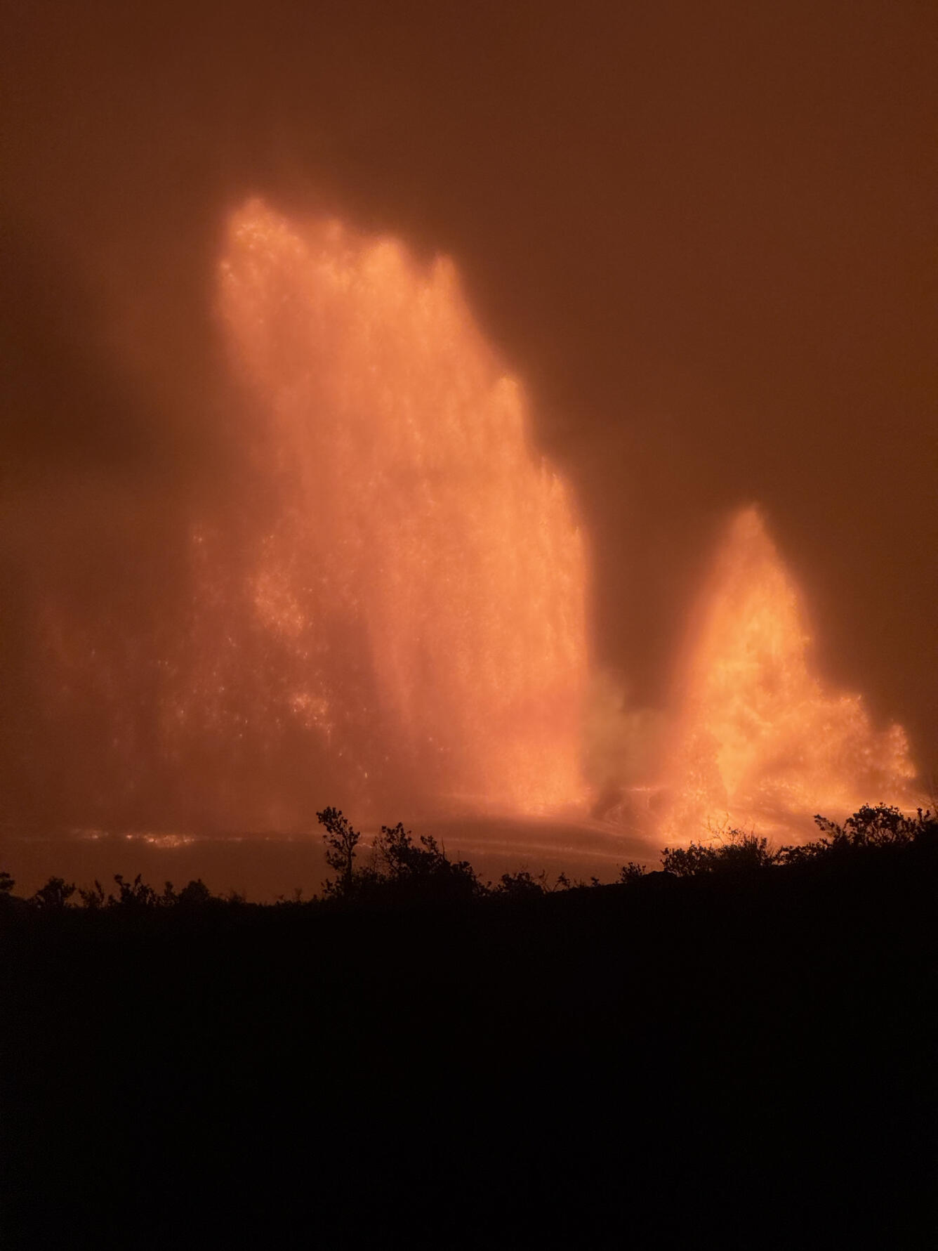 Color photograph of lava fountains at night