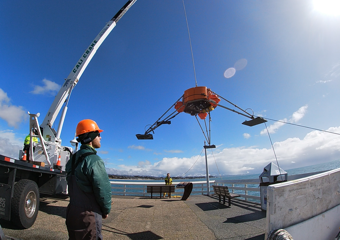 Image shows Free Ascent Tripod (FAT) lifted by a crane during a test deployment
