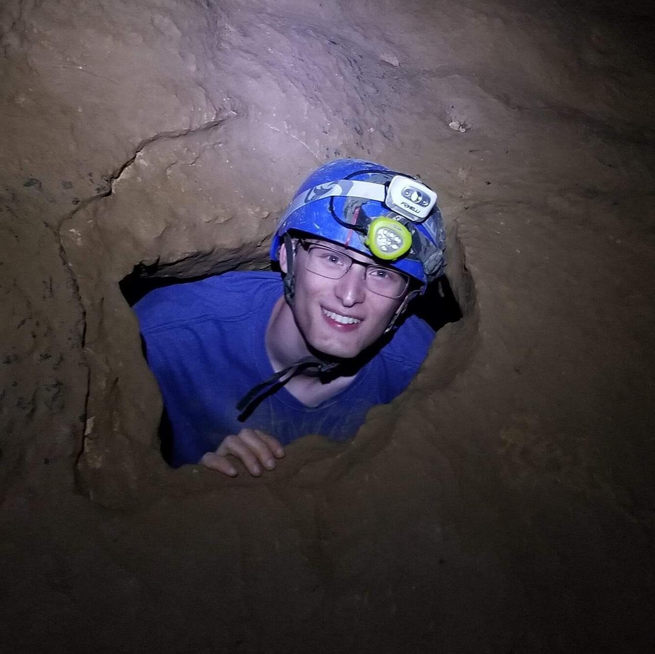 Nick Powell smiles for the camera during a caving expedition 