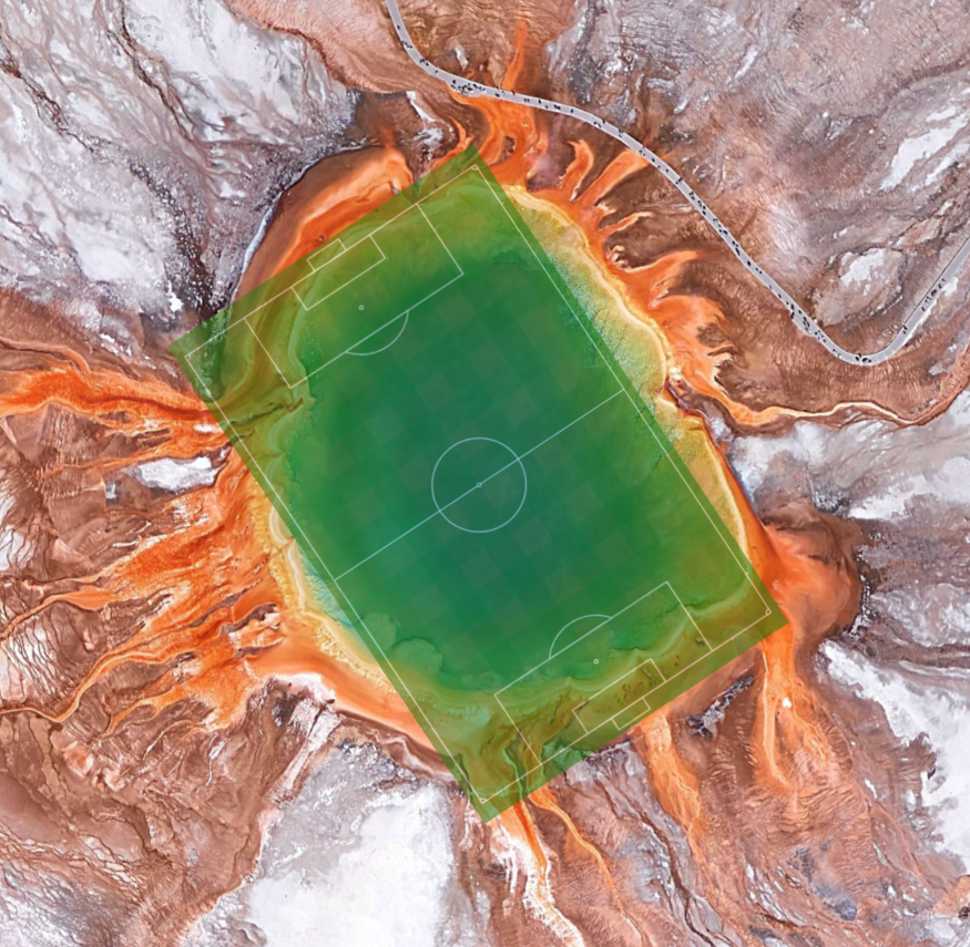 Aerial view of colorful Grand Prismatic Spring with a soccer field overlain and covering the spring's area almost exactly