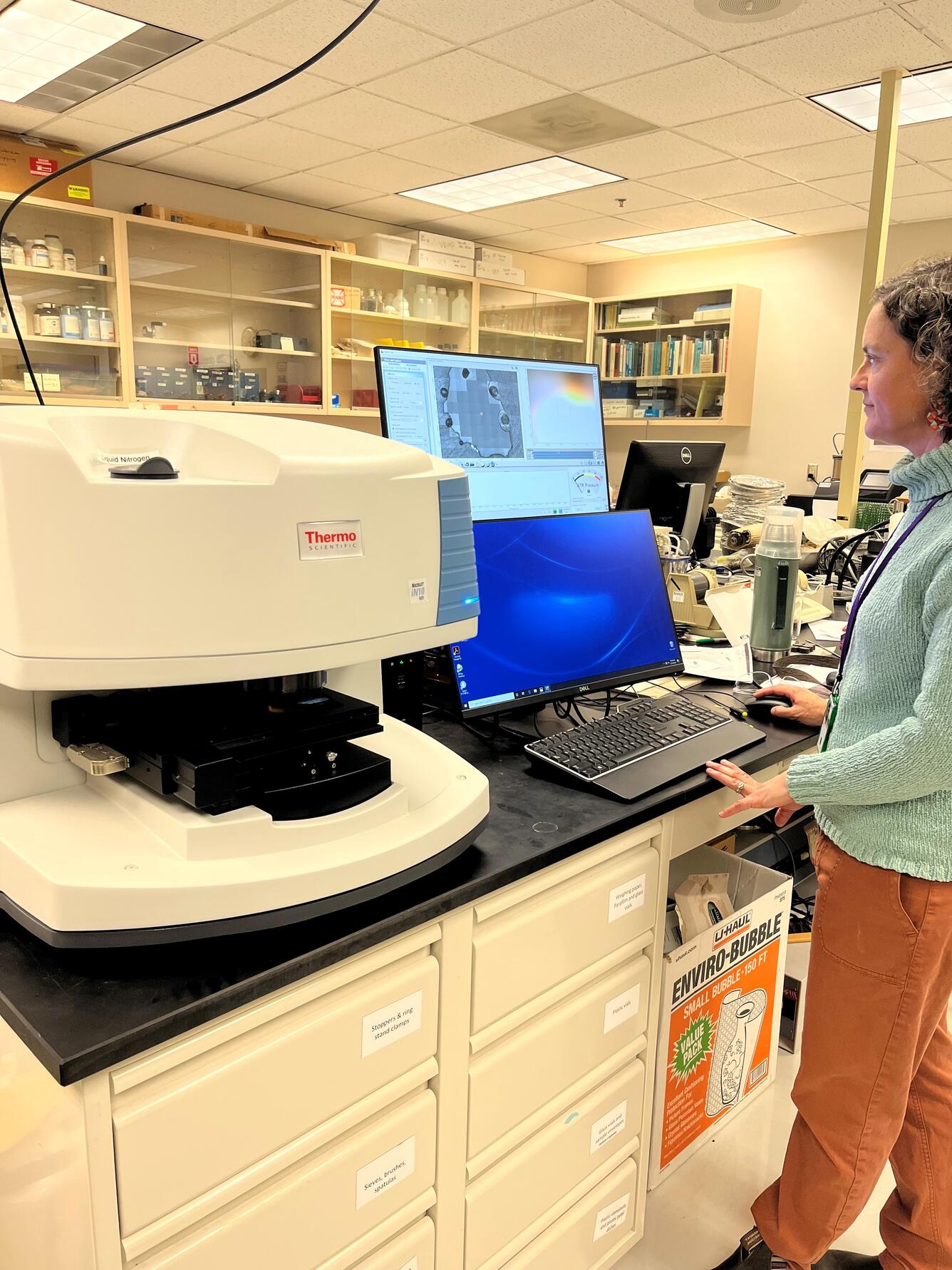 Research Scientist Emily Johnson calibrates the FTIR in the CVO Petrology Lab