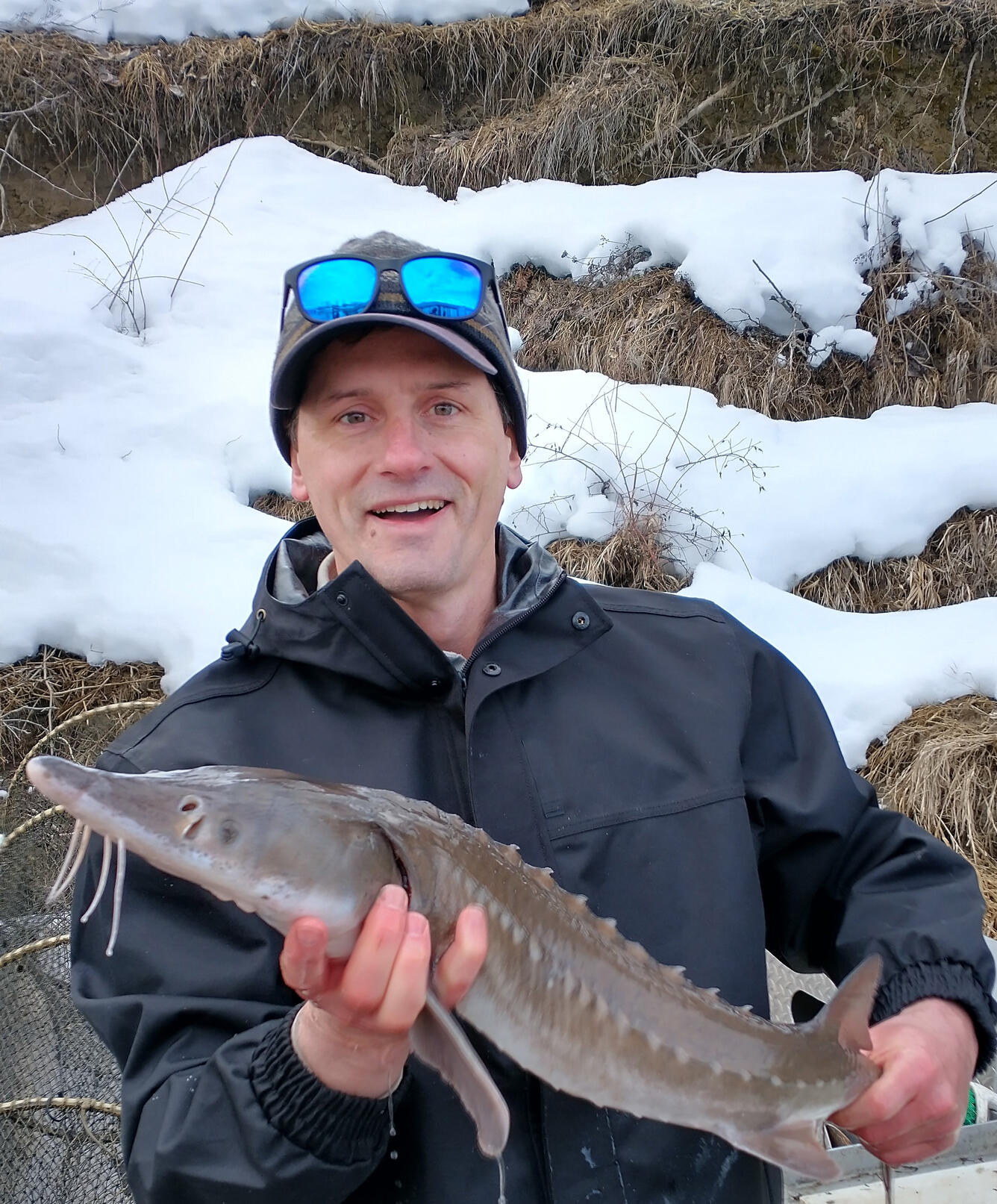 scientist holding a sturgeon fish