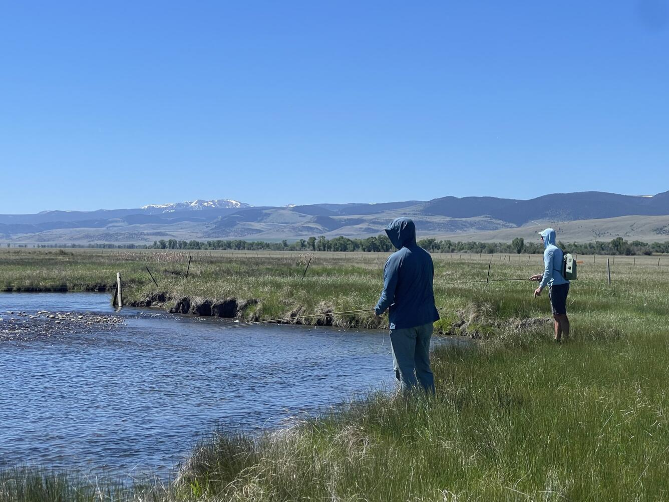 Two anglers on the banks of a river