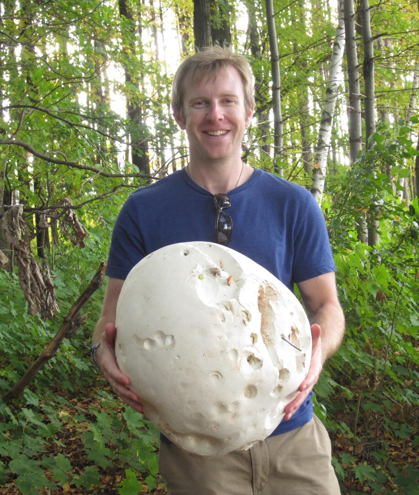 Matthew Fisk holding a large mushroom