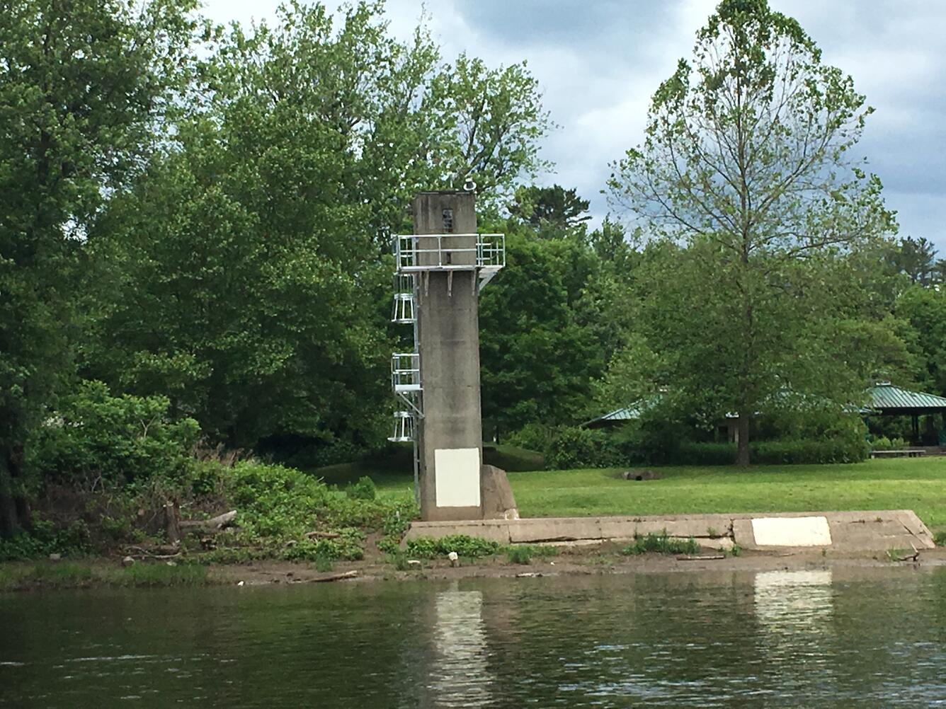 Looking at the concrete tower of the gage from across the river