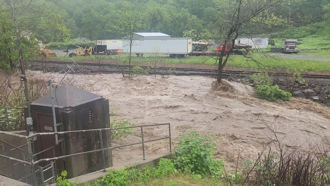 A flooded creek next to a USGS streamgage.