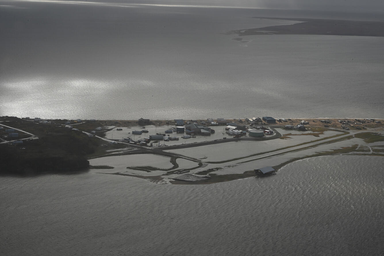 Aerial view of flooded land and buildings along the coast at Golovin, Alaska