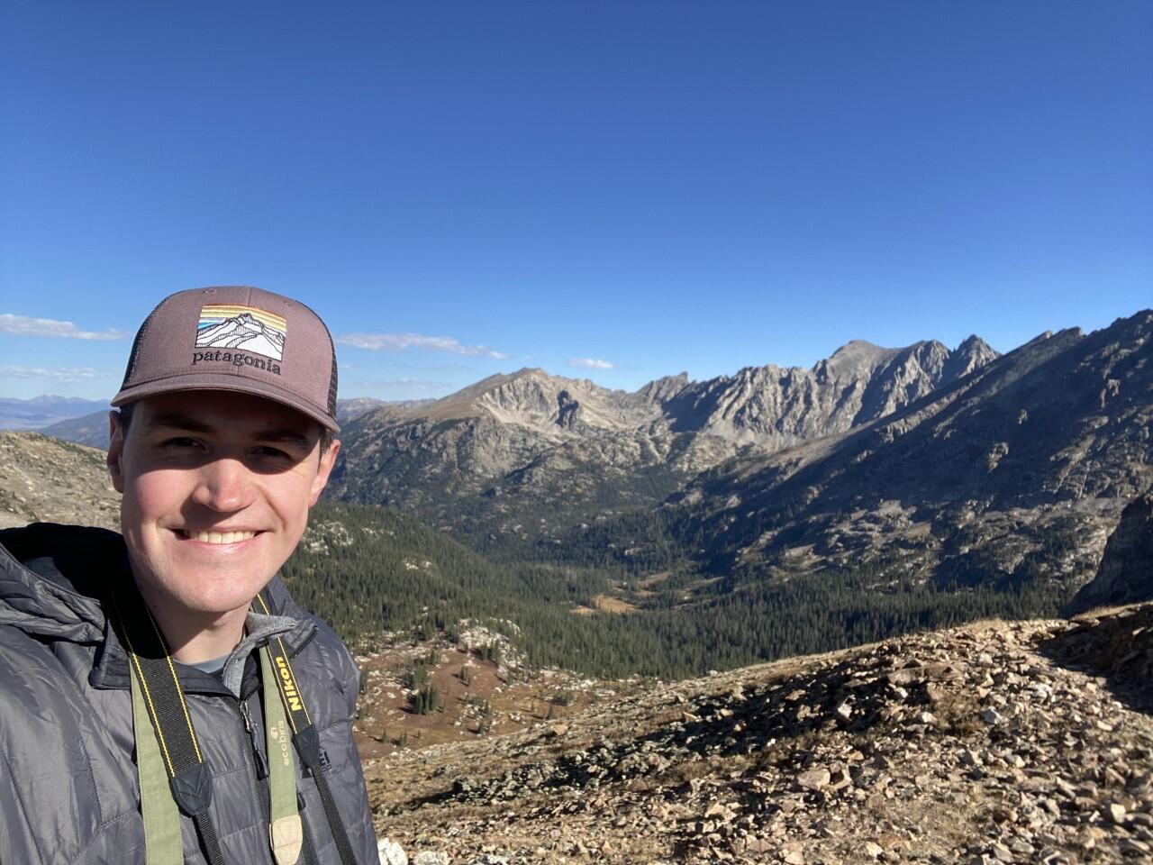 person with mountains in the background