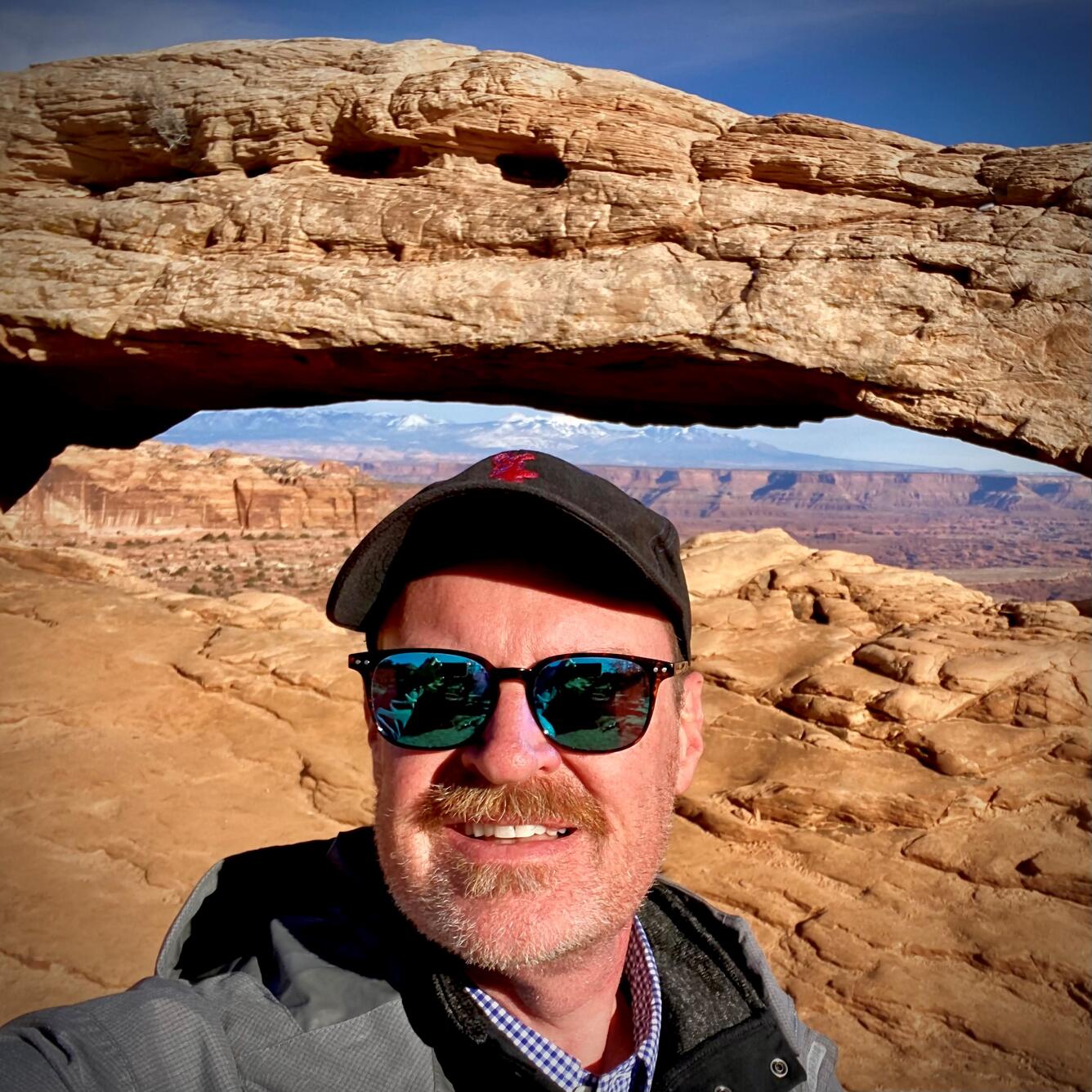 Gregory Shelton in front of a mountain structure