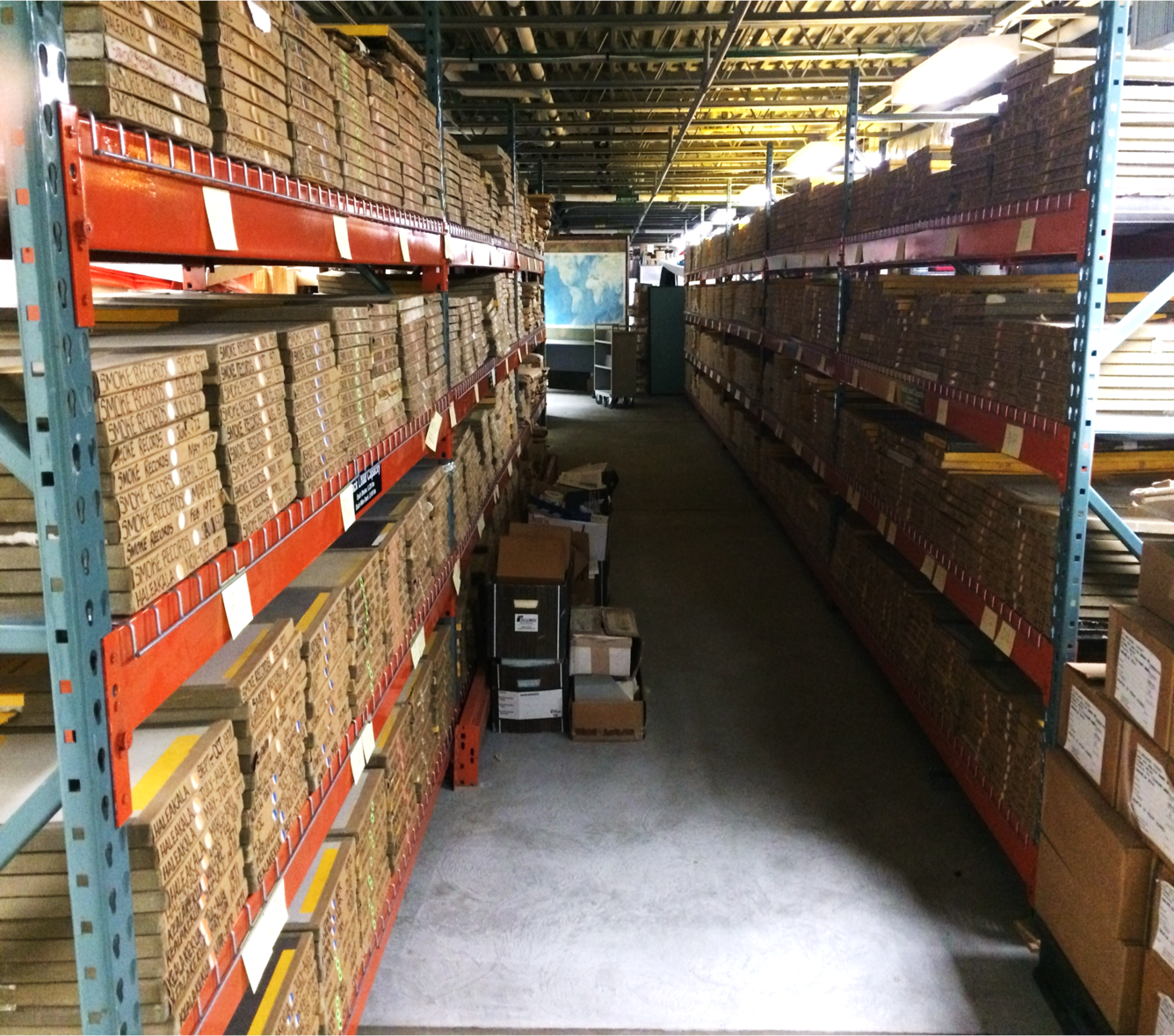Color photograph of shelves with cardboard boxes on them