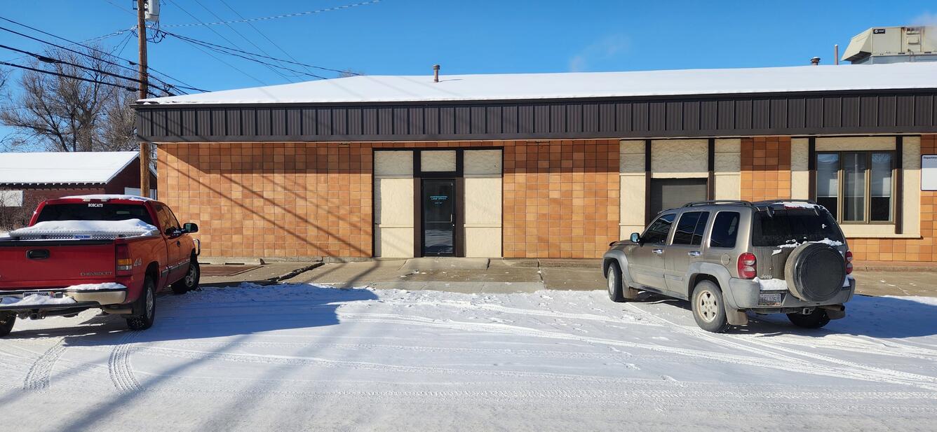 An image of the Havre Office during winter - a brown and tan building. 