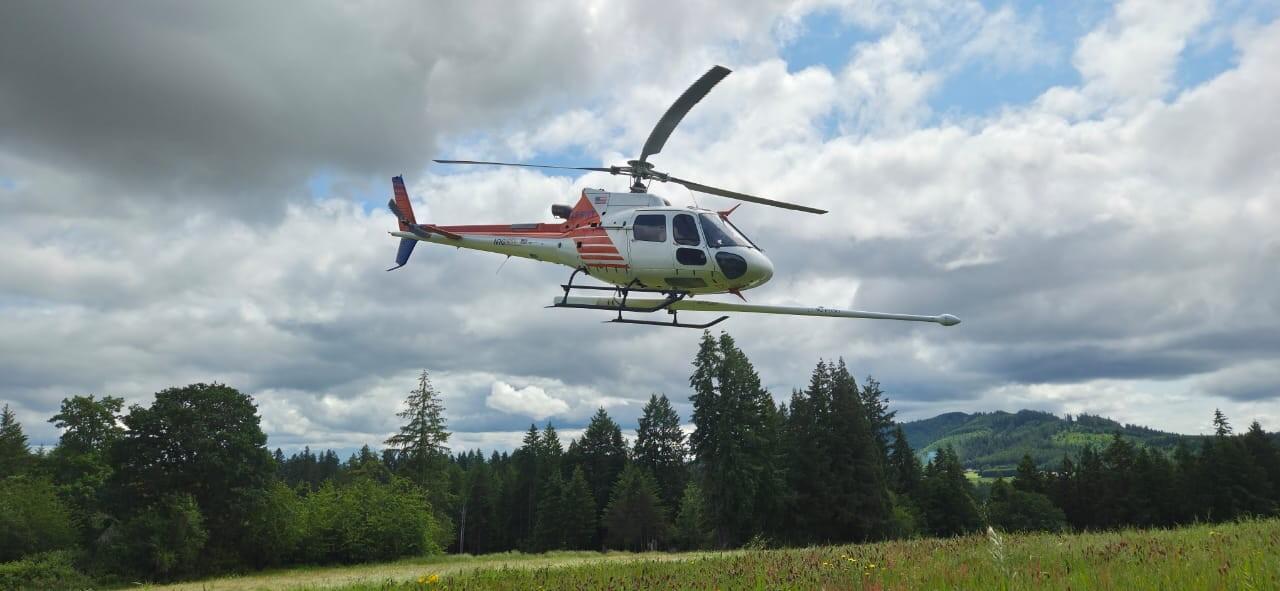 red and white helicopter with the “stinger” extending forward