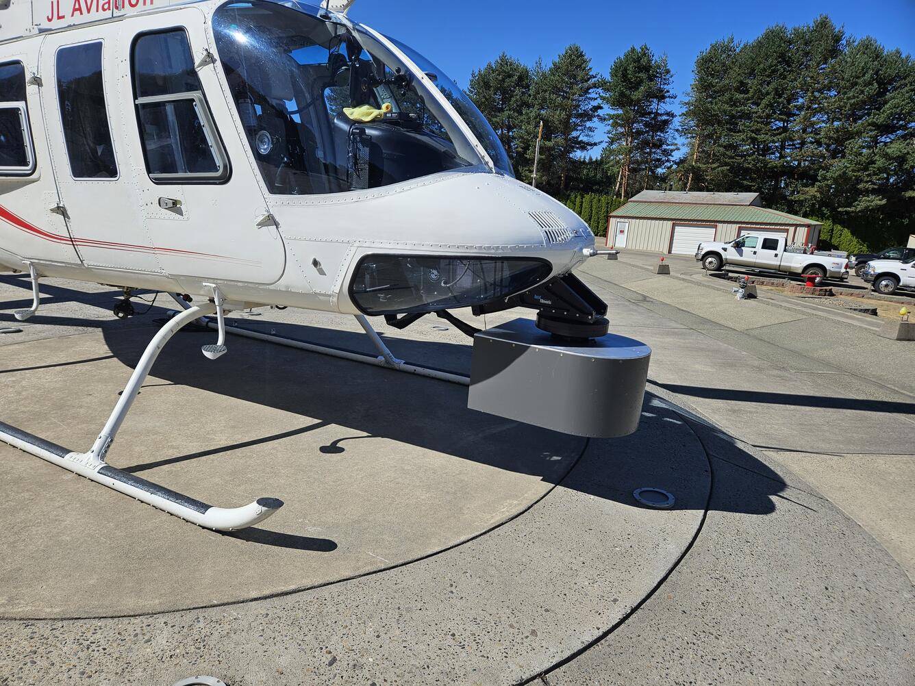 Bell Jet Helicopter with a thermal infrared and true-color sensor co-mounted to the underside