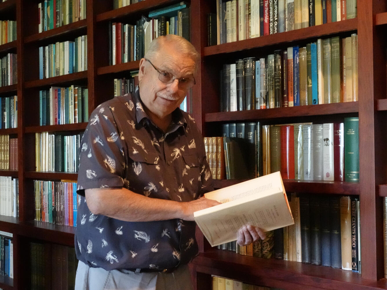 Charles Henny holding a book