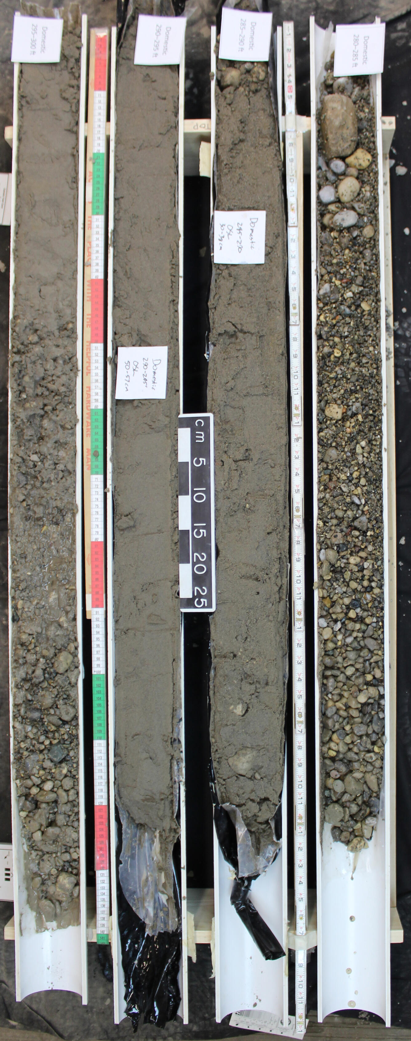 This image of a drill core shows four sections of core in casings with sediment ranging in size from gravel to silt. 