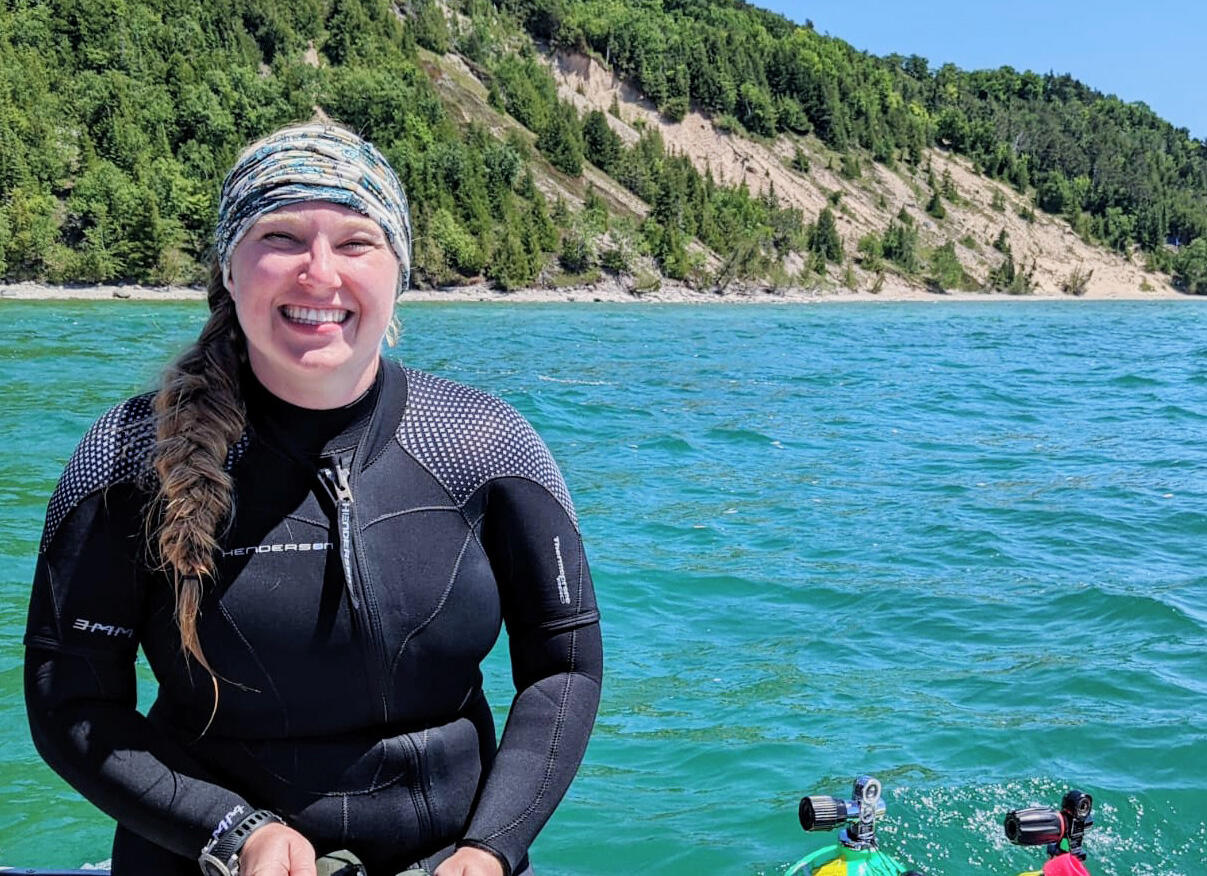 Megan Lewan in a wet suit on a boat