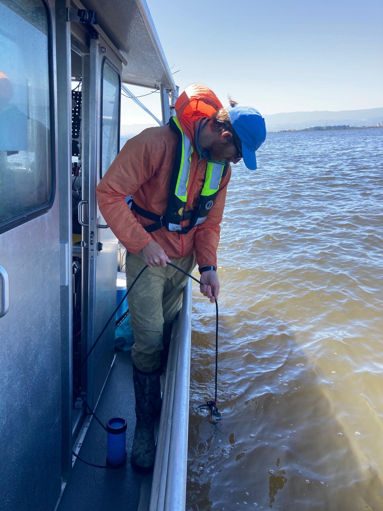 man putting line in water