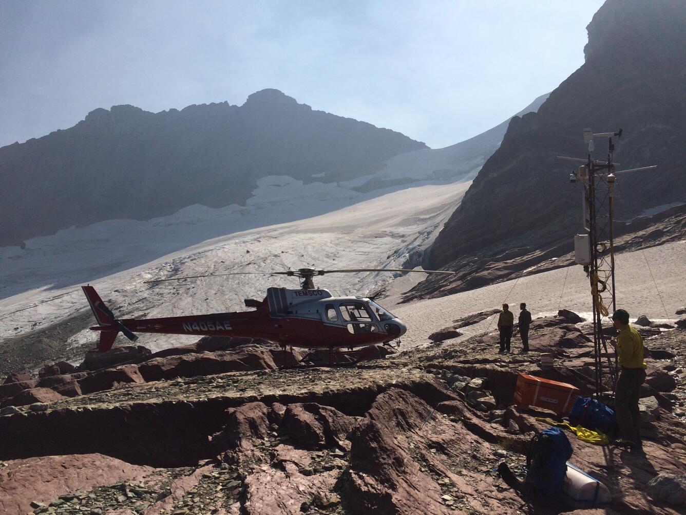 a helicopter on a mountain side that USGS scientists used to access high elevation weather station