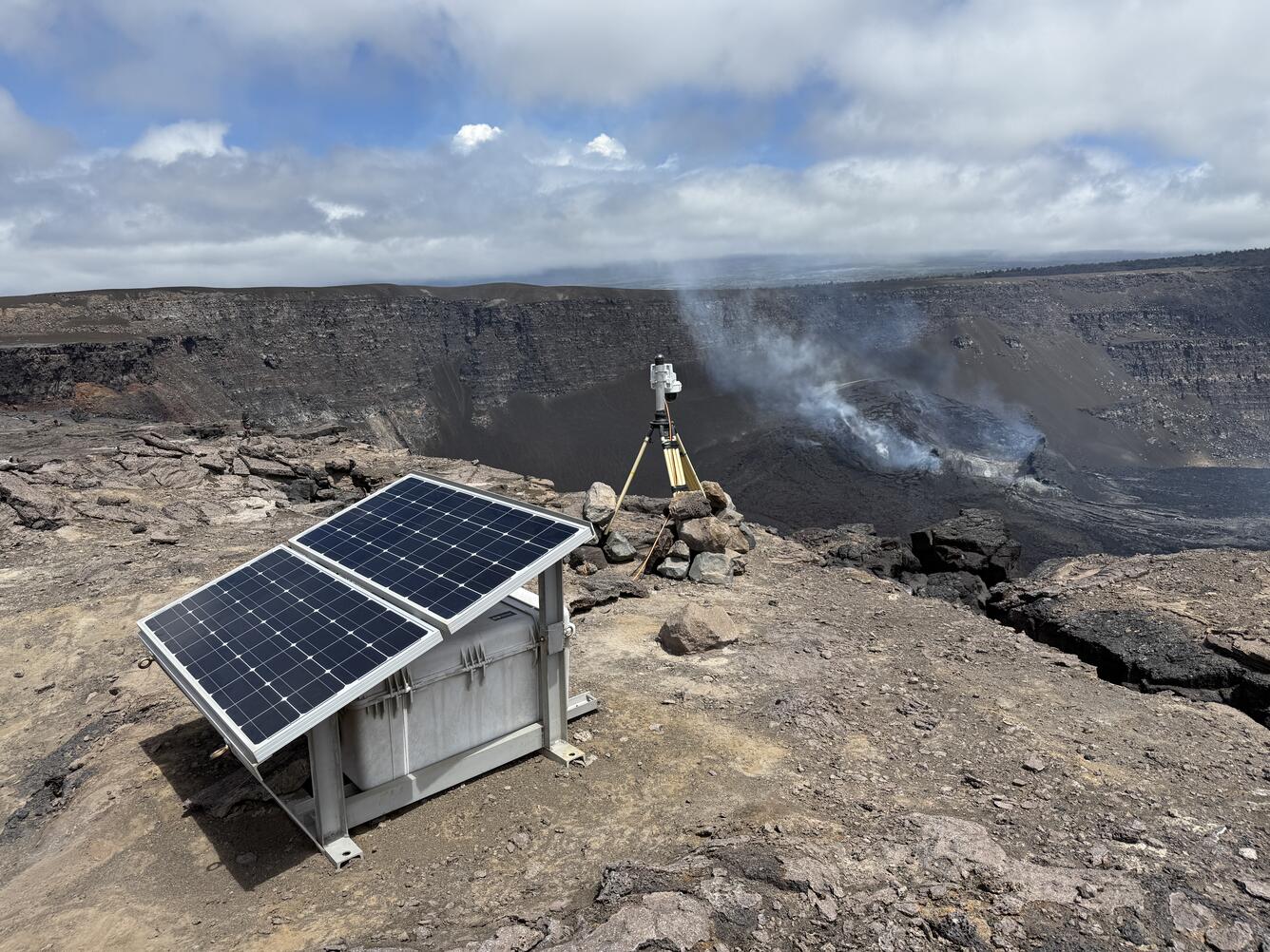 Color photograph of volcano monitoring webcamera station on the rim of a crater