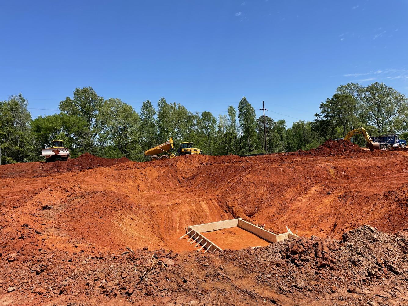 Deep pump sump pit excavation shown with concrete forms in place.