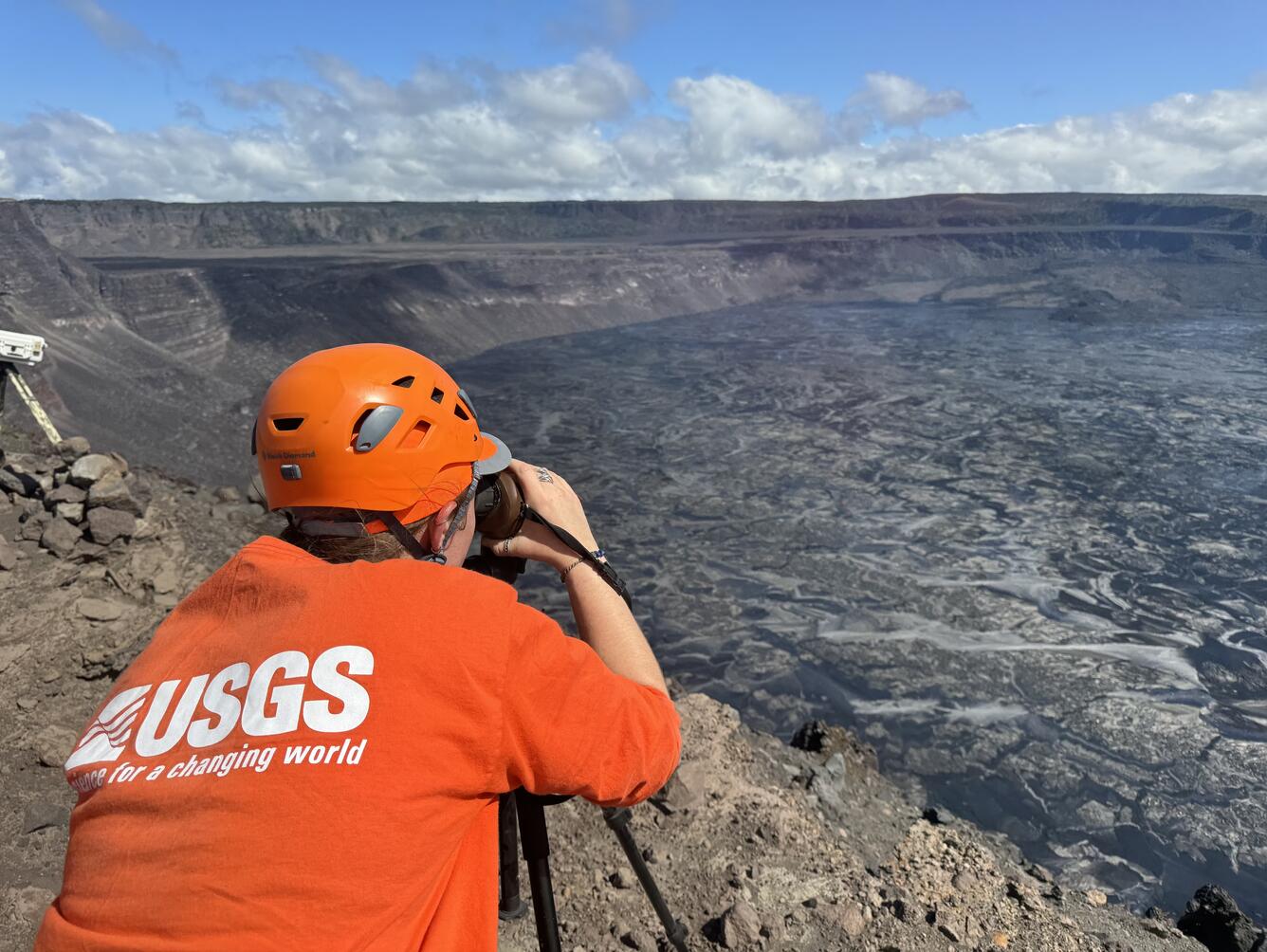 Color photograph of scientist monitoring eruption