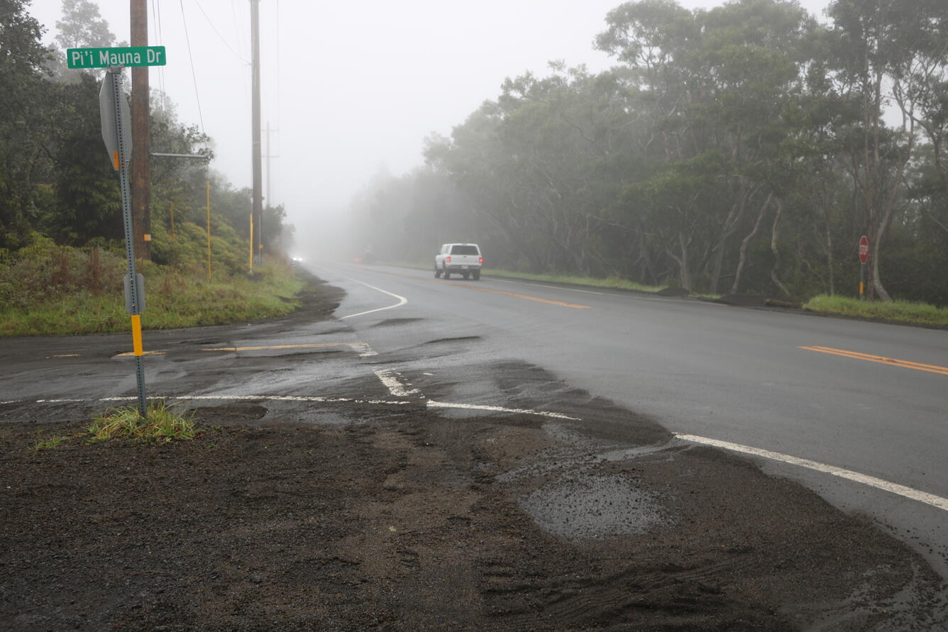 Color photograph of highway with volcanic fallout material cleared