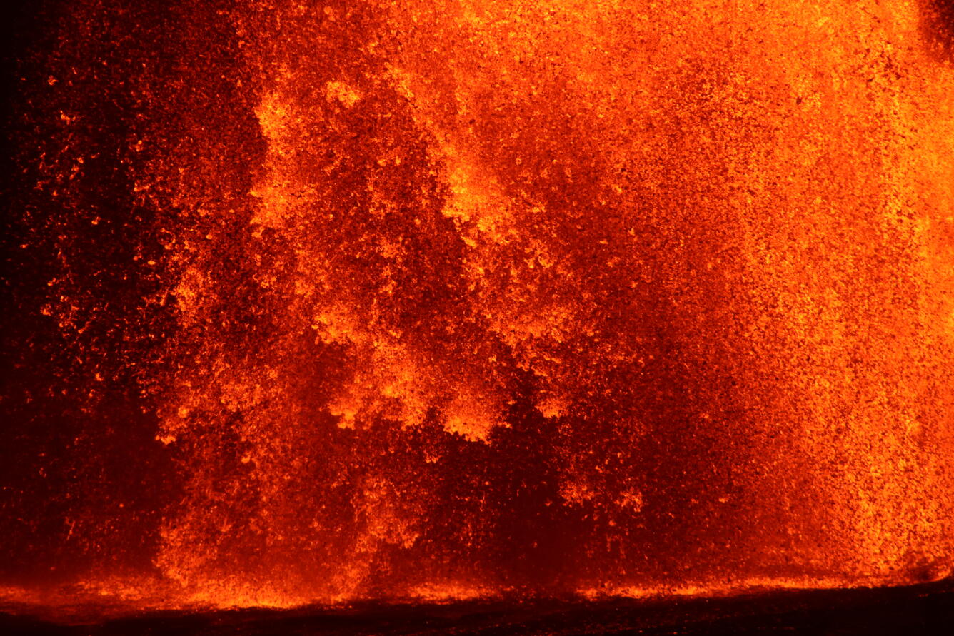 Color photograph of lava fountain at night