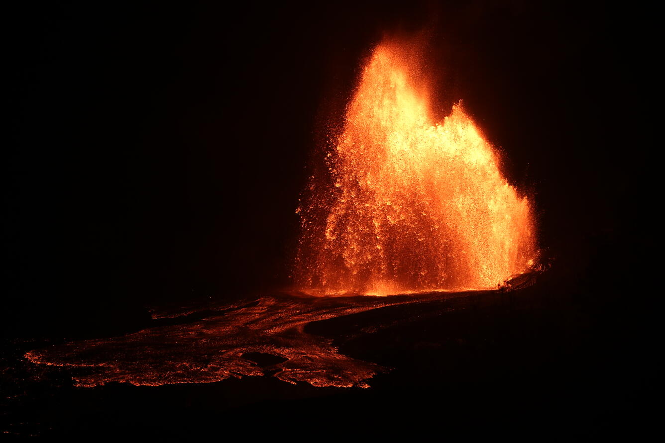 Color photograph of lava fountain at night