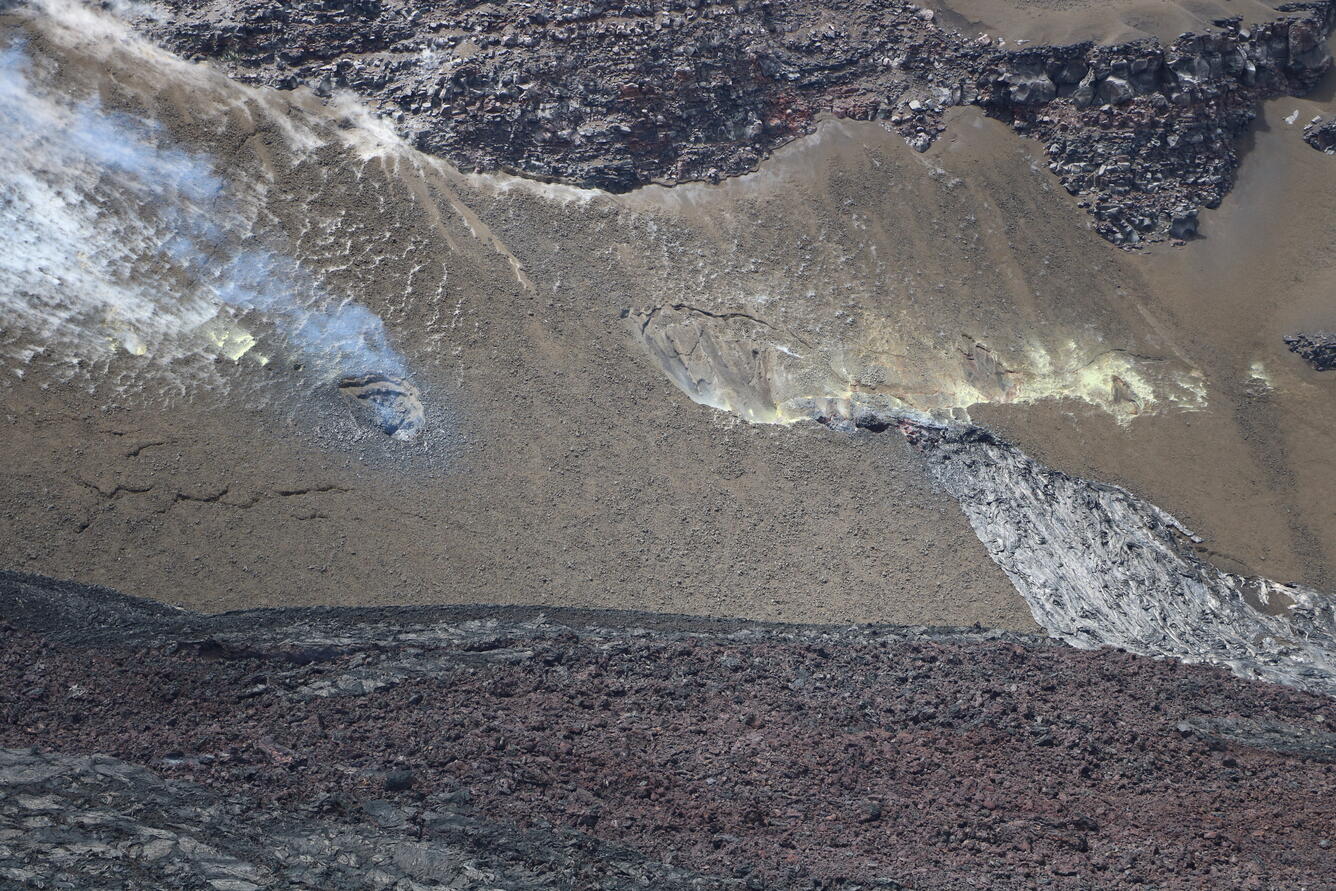 Color photograph of volcanic vents in wall of crater