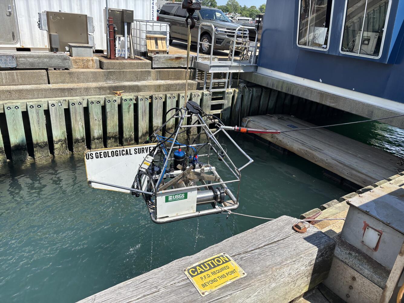 Equipment being lowered into the water off a dock