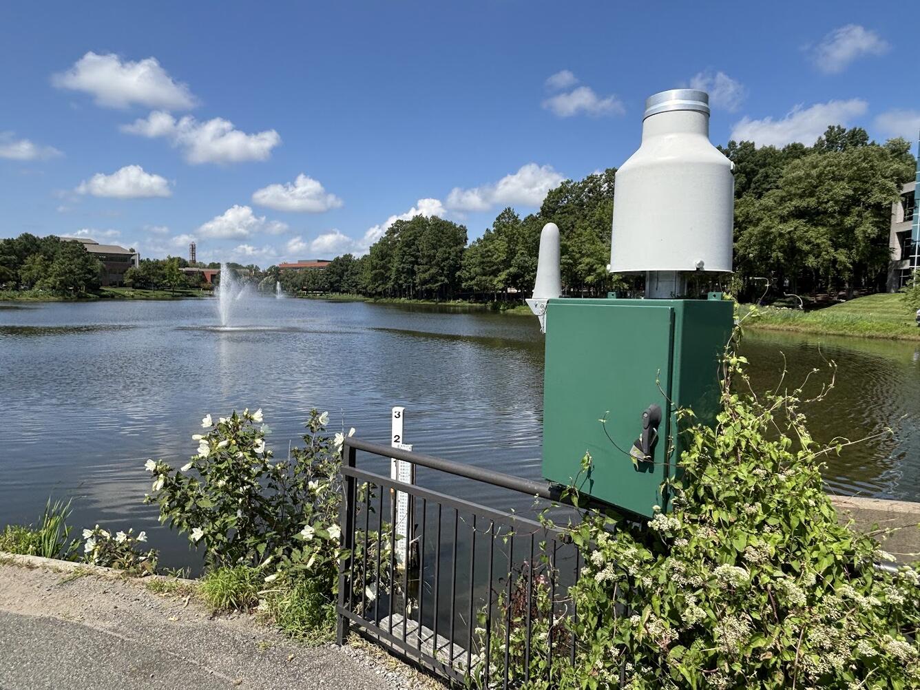 USGS hydrologic monitoring station along an urban waterfront walking path.