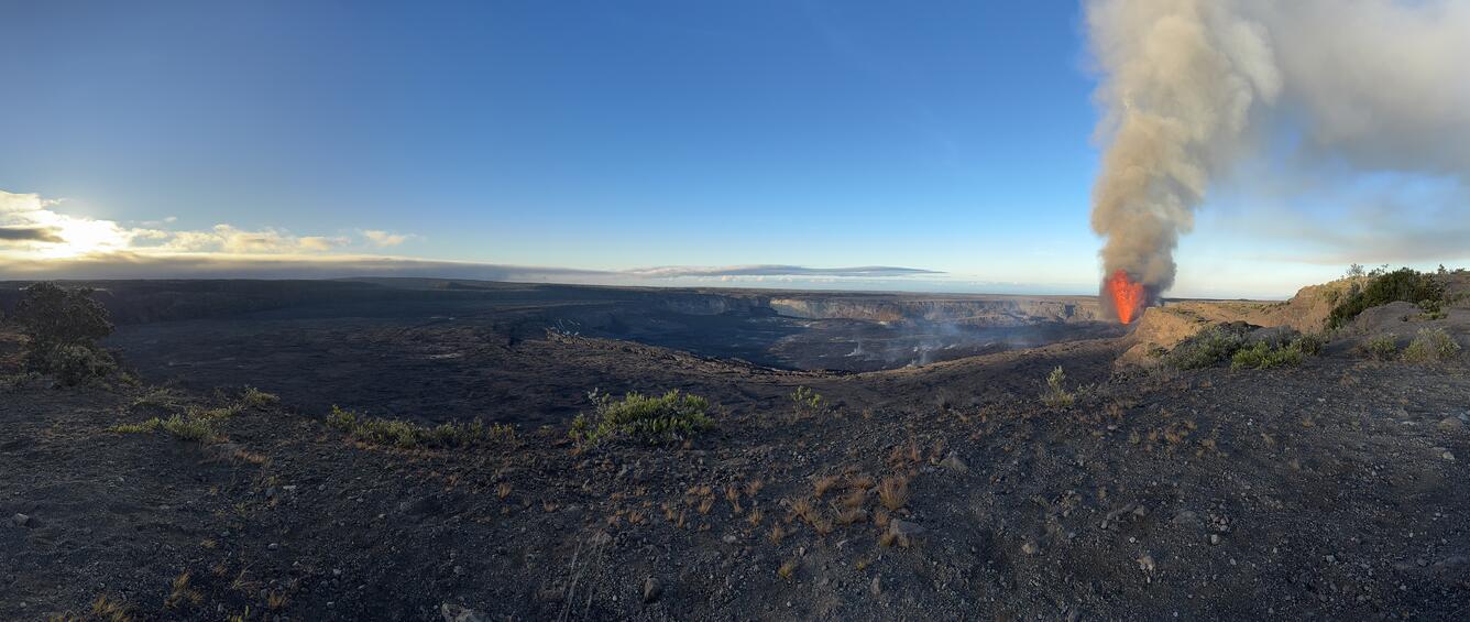 Color panoramic photo of a volcanic caldera with eruption
