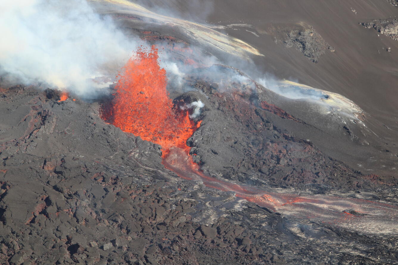 Color photograph of volcanic vent erupting