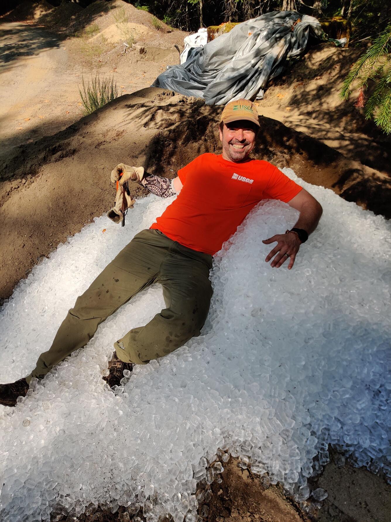 USGS Scientists Maciej Obryk sits in ice at the HJ Andrews Experimental Forest in Blue River, Oregon.