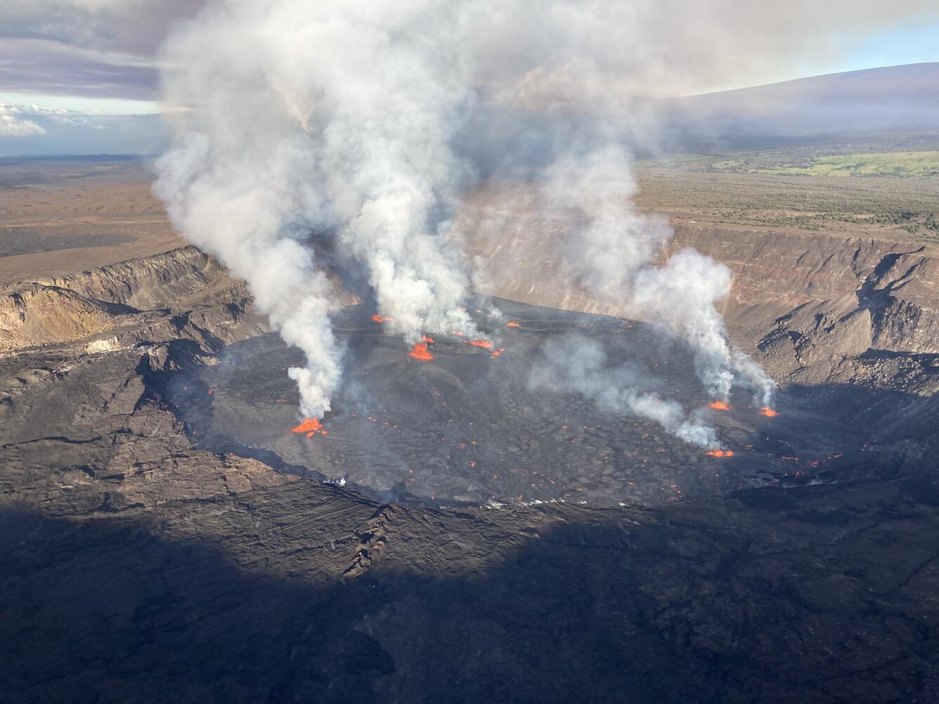 Aerial view of Halema‘uma‘u crater showing active vent sources and lava flooding the crater floor