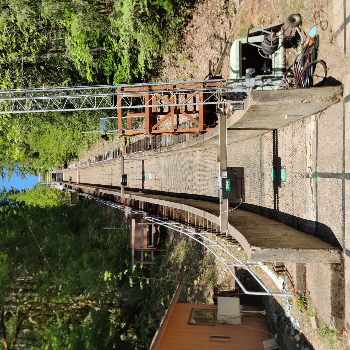 Photo of the experimental debris flow flume looking up towards the top of the wooden flume. 